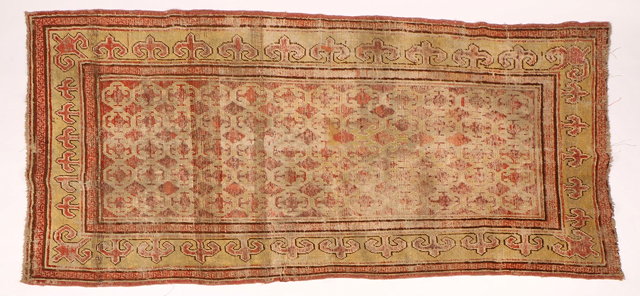 Appraisal: AN ANTIQUE KHOTAN RUG with central cloud lattice design within