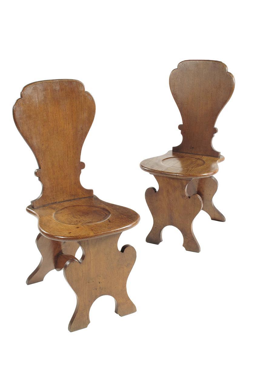 Appraisal: A pair of Victorian oak hall chairs