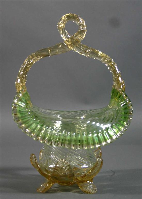 Appraisal: Yellow art glass basket with green trim Twisted vine handle