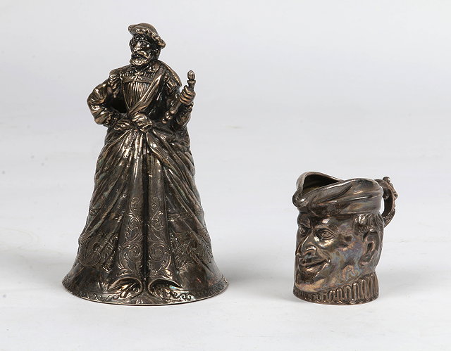 Appraisal: A CONTINENTAL TABLE BELL in the form of a robed