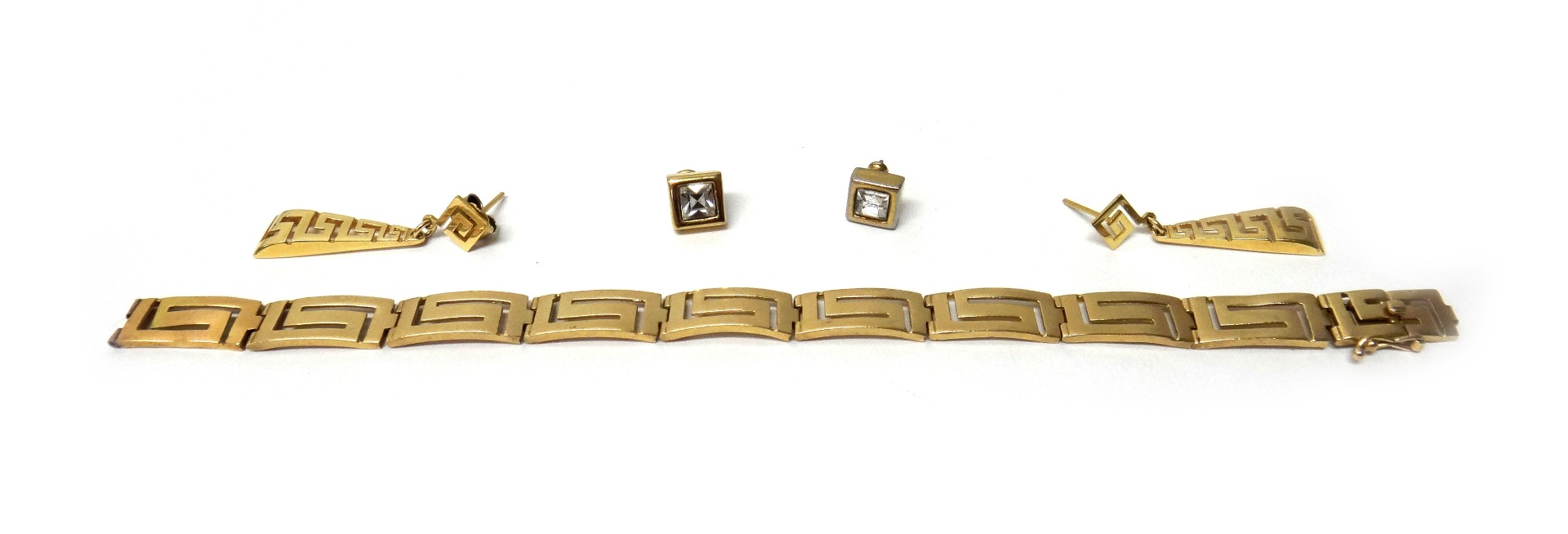 Appraisal: A gold bracelet pierced in a Greek key pattern curved