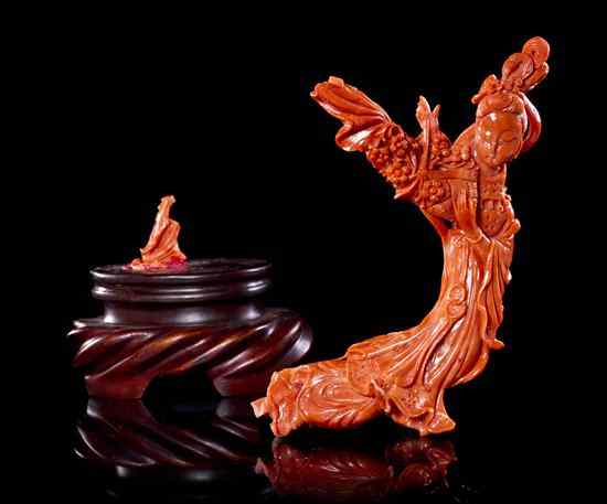 Appraisal: A Carved Coral Model of a Woman of deep orange