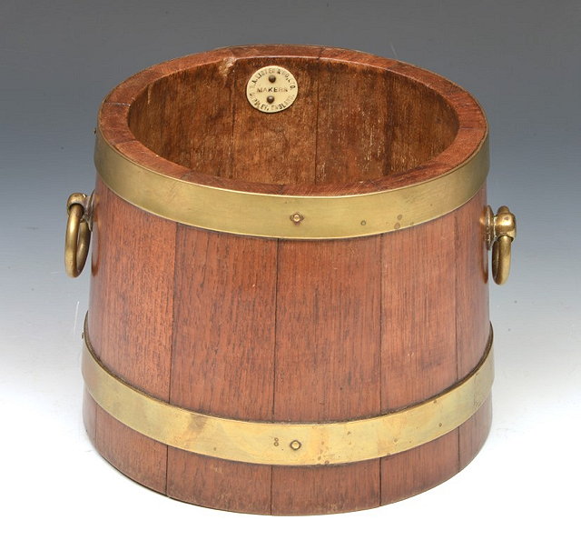 Appraisal: AN OAK AND BRASS BOUND JARDINIER by Lister and Co