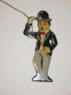 Appraisal: An English novelty two dimensional tin toy depicting Charlie Chaplin