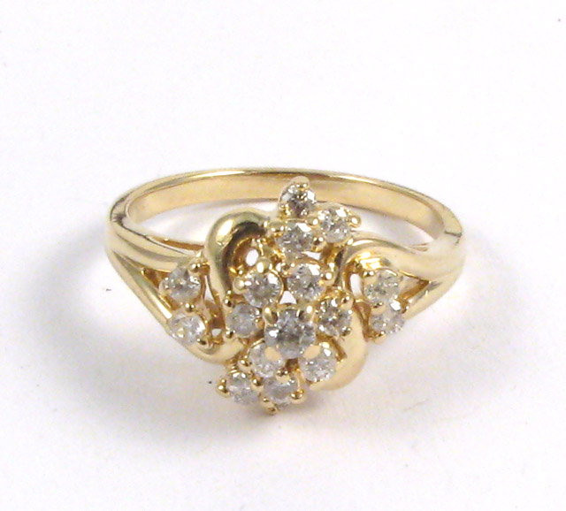 Appraisal: DIAMOND AND FOURTEEN KARAT GOLD CLUSTER RING set with round-cut