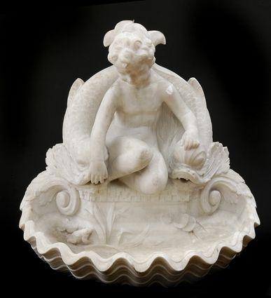 Appraisal: ITALIAN CARVED MARBLE WALL FOUNTAIN Centered by a seated putto