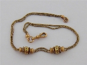 Appraisal: A French carat gold watch chain weighted with a pair