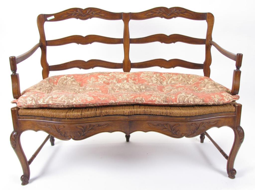 Appraisal: A Country French style settee with carved frame ladder back