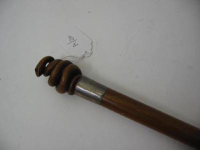 Appraisal: A GENTLEMAN'S WALKING CANE the pommel carved and pierced as