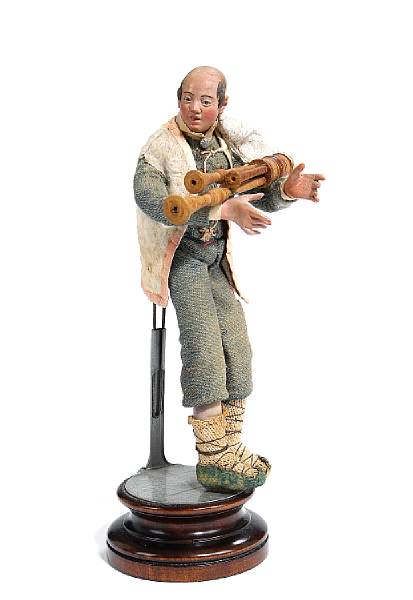 Appraisal: An Italian cr che figure of a musician with bagpipes