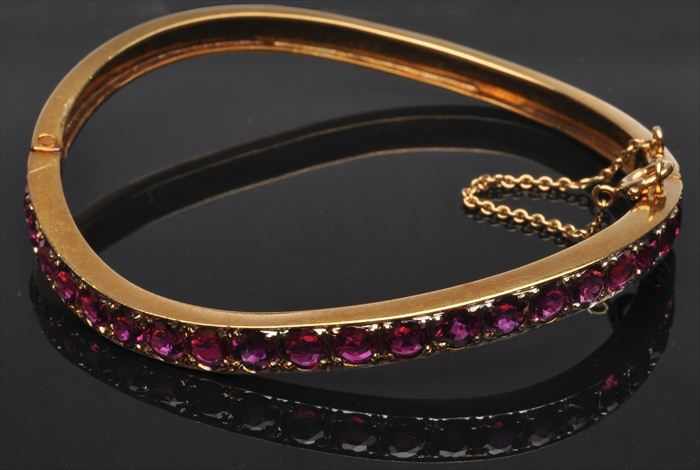 Appraisal: GOLD AND RUBY BANGLE BRACELET Stamped