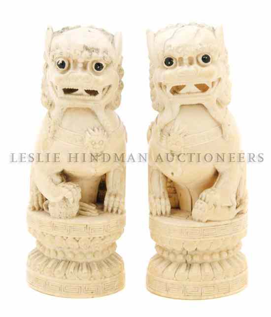 Appraisal: A Pair of Chinese Carved Ivory Fu Dogs the seated