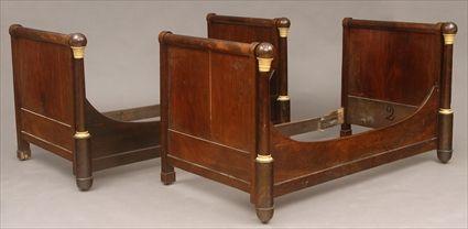 Appraisal: PAIR OF EMPIRE GILT-METAL MOUNTED MAHOGANY BEDSTEADS The paneled ends