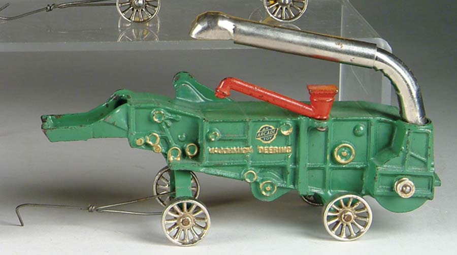 Appraisal: MCCORMICK-DEERING COMBINE BY ARCADE Painted in green and embossed MCCORMICK-DEERING