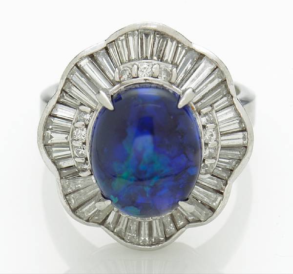 Appraisal: A black opal and diamond ring centering an oval-shaped opal