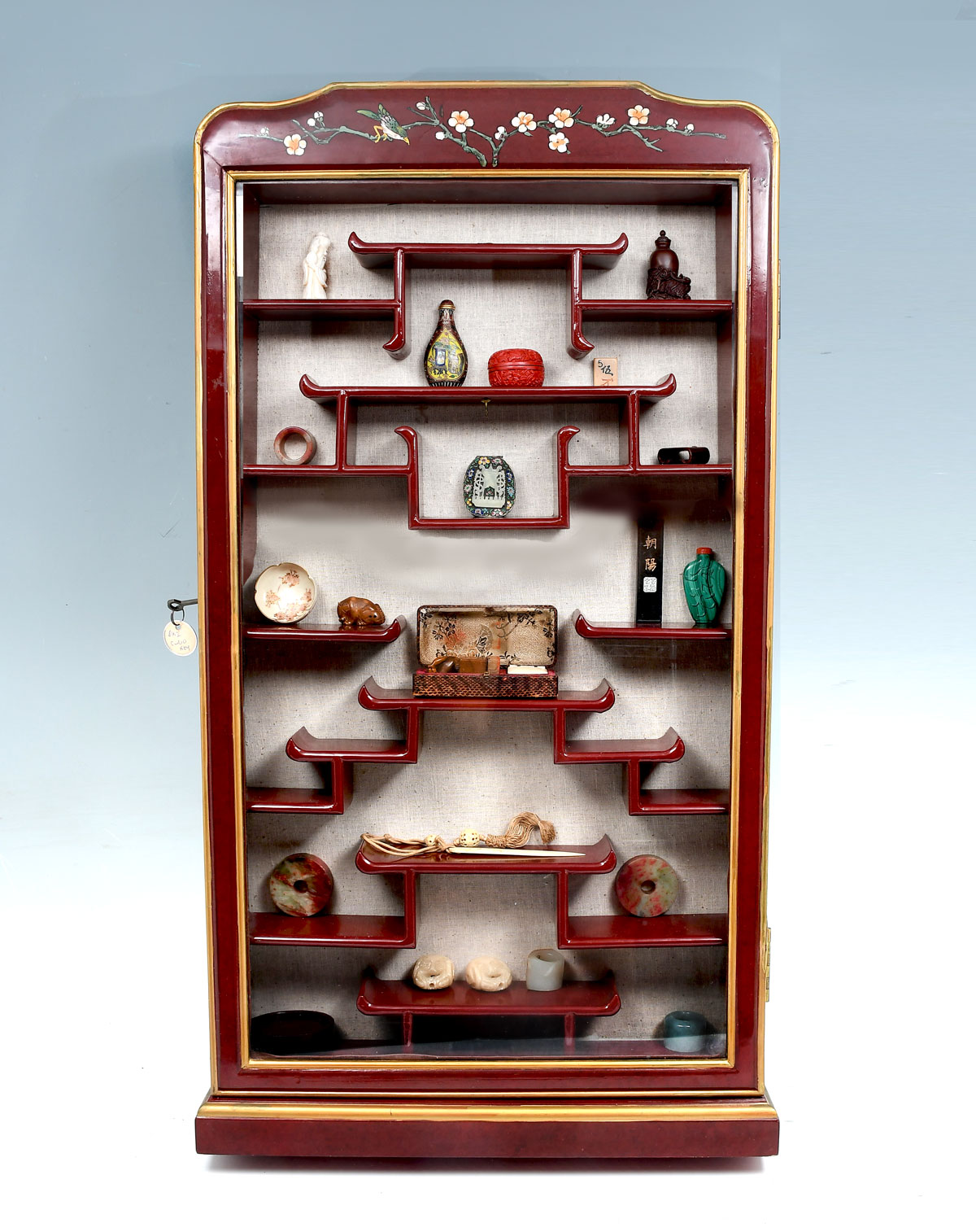 Appraisal: CHINESE DISPLAY CABINET AND CONTENTS Chinese lacquered netsuke cabinet with