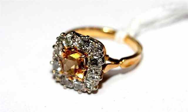 Appraisal: A CITRINE AND DIAMOND SET RING central cushion cut stone