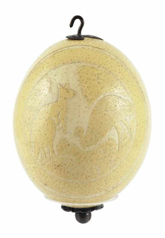 Appraisal: A CARVED OSTRICH EGG WITH METAL MOUNTS Carved within an