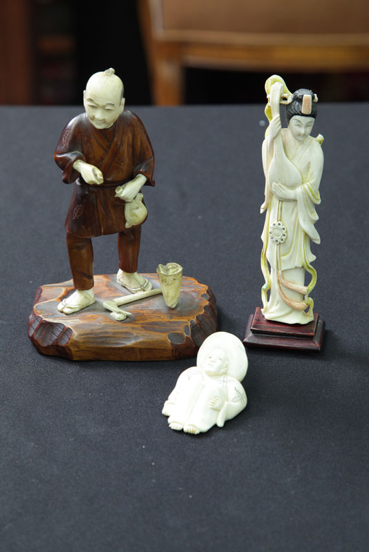 Appraisal: THREE CARVED IVORY FIGURES Including one figure of a woman