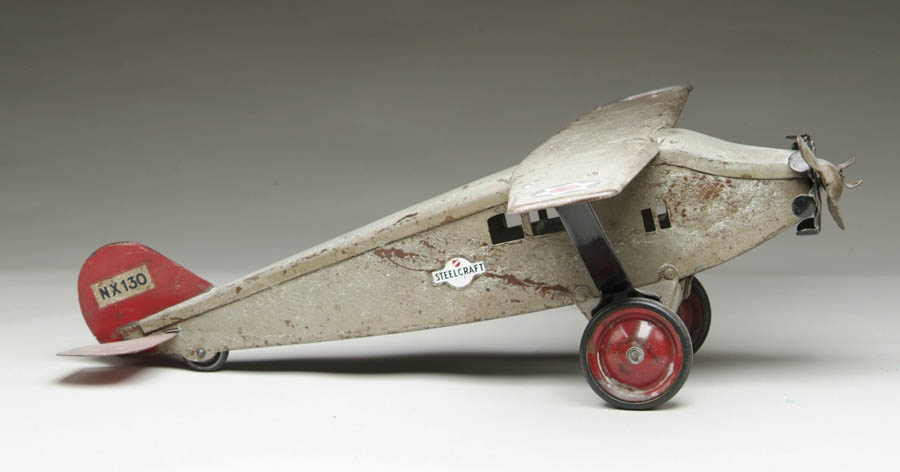 Appraisal: STEELCRAFT MONOPLANE Gray painted plane with red tail fins cutout