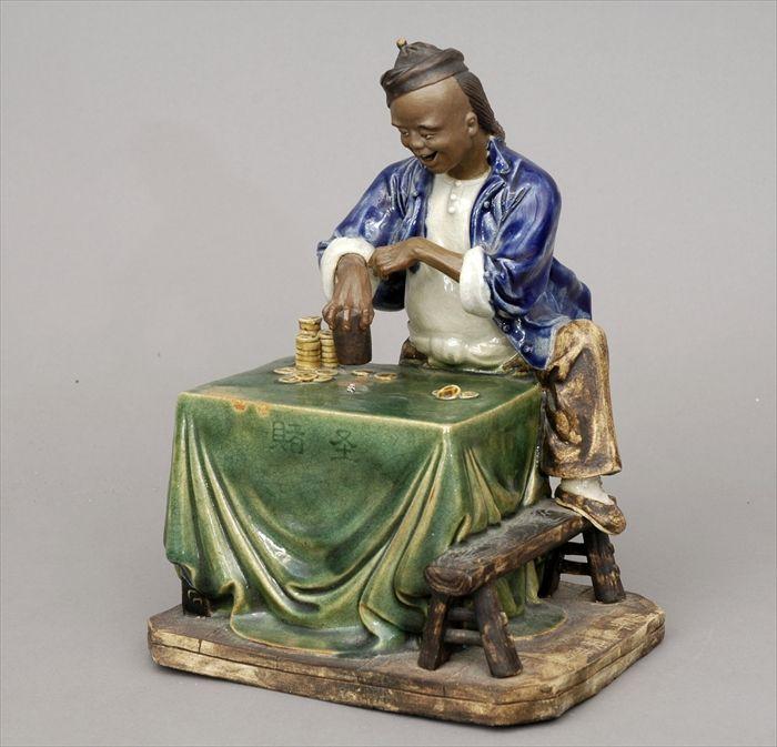 Appraisal: Chinese Glazed Pottery Figure of a Dice Player x in