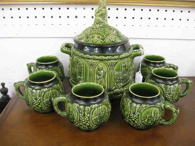 Appraisal: German Pottery Punchbowl and Mugs figure on top various town