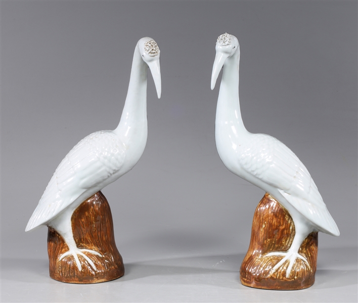 Appraisal: Pair Chinese white glazed porcelain birds each atop brown glazed