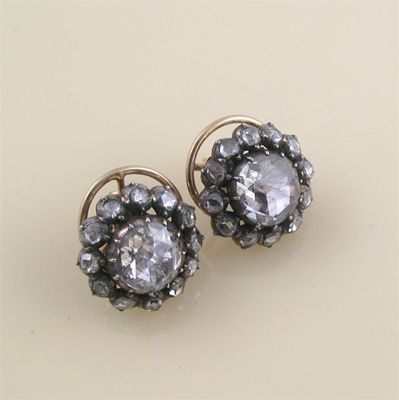 Appraisal: A pair of diamond cluster earrings Each earring centred with