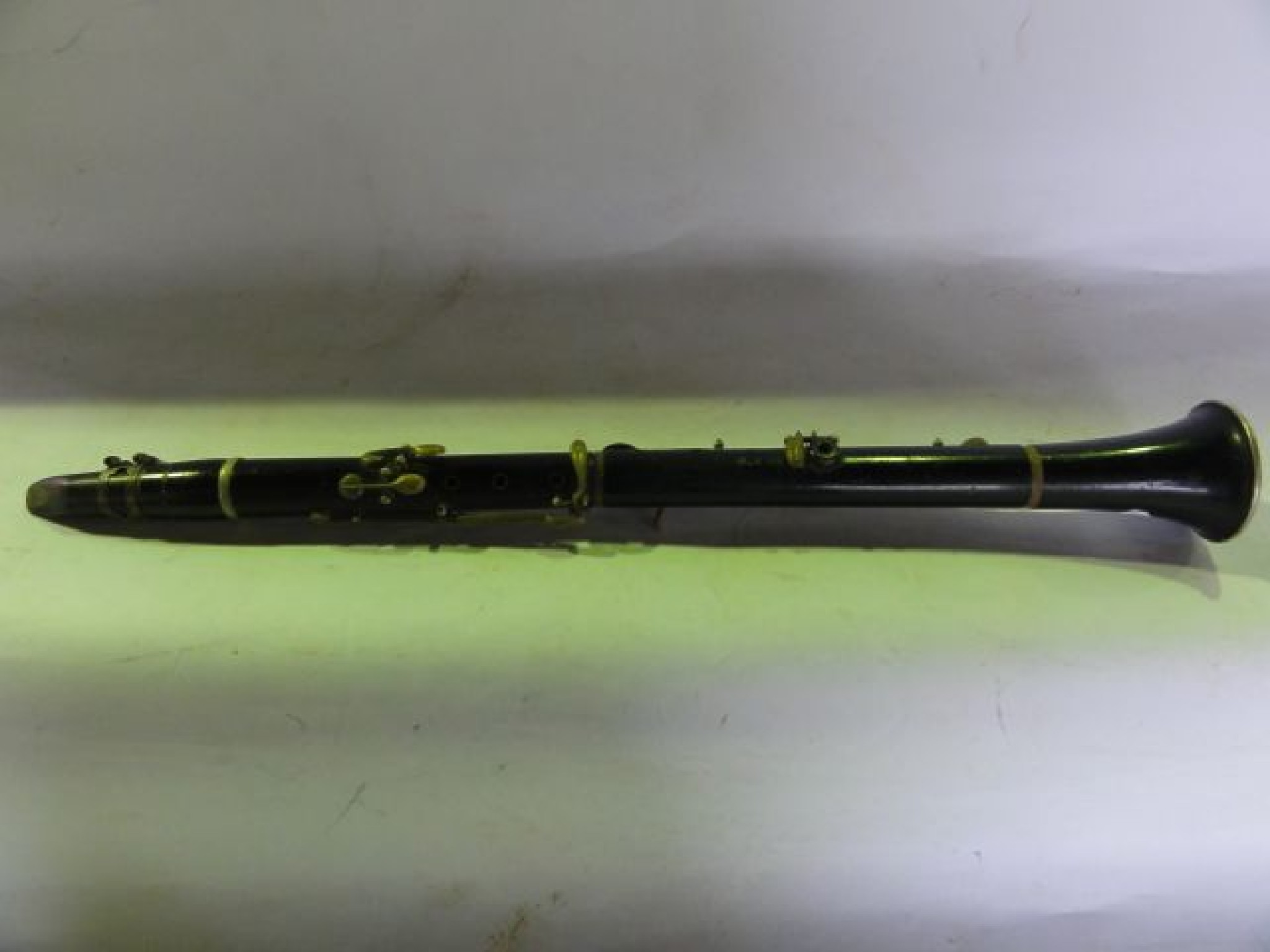 Appraisal: An old clarinet with ebonised timber composition with metallic mounts