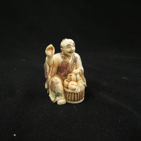 Appraisal: Chinese Carved Ivory Netsukeof seated man with baskets of fruit