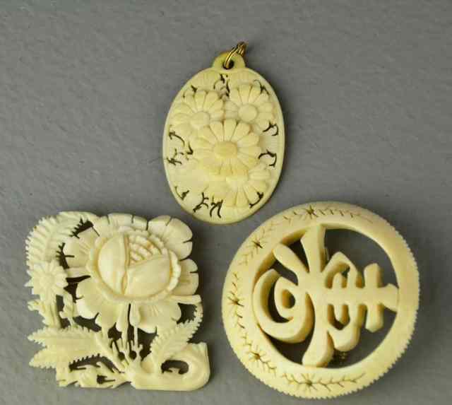 Appraisal: Chines Carved Ivory PendantsAll finely carved depicting symbols lotus blossoms