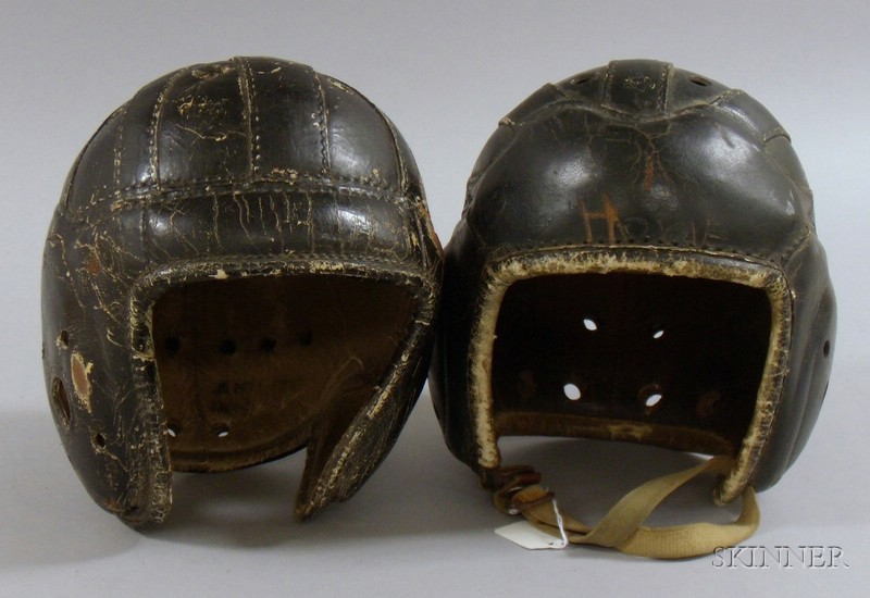 Appraisal: Two Vintage Black Painted Leather Football Helmets one with Tim