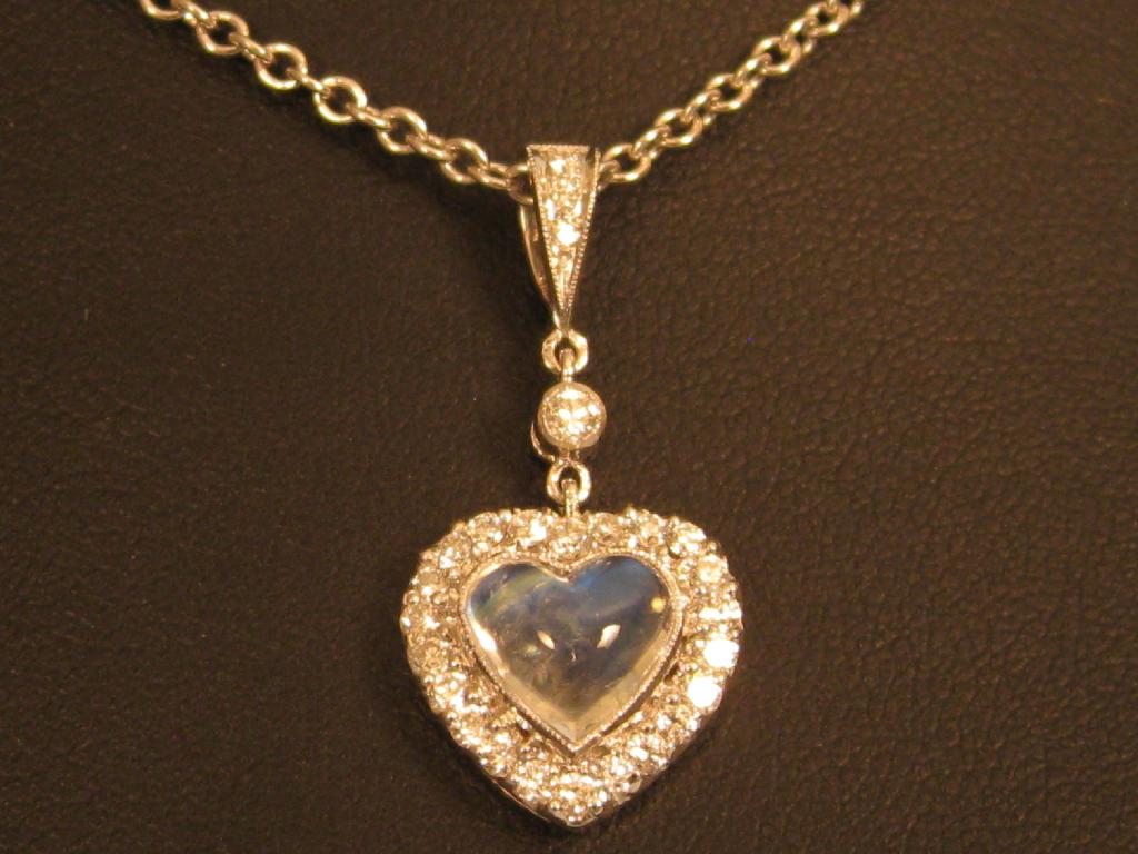 Appraisal: A Moonstone and Diamond Pendant the central heart shaped cabochon