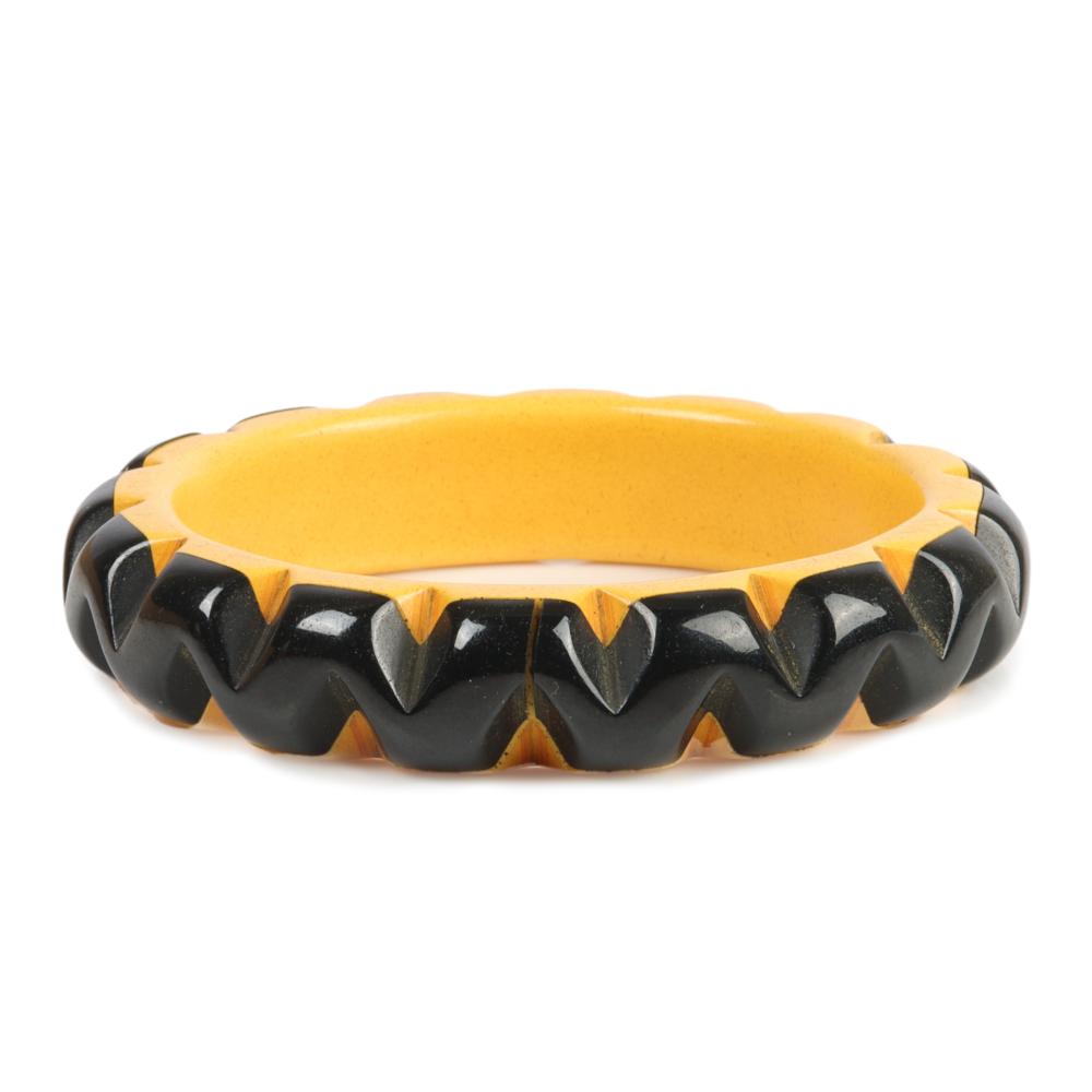 Appraisal: BAKELITE CAST CARVED CREAM AND BLACK BANGLE BRACELET WITH LAMINATED