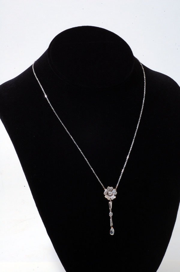 Appraisal: Marked K white gold flower pendant set with round diamonds