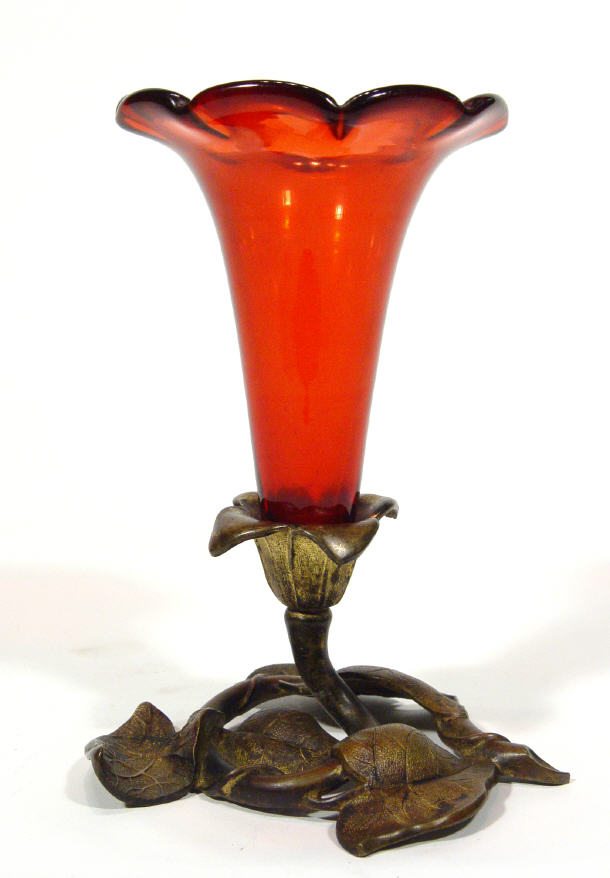 Appraisal: Cranberry coloured glass vase on a naturalistic leaf design ormolu