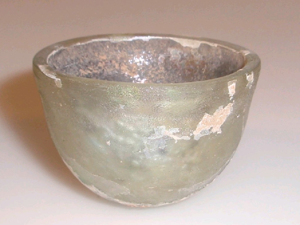 Appraisal: A small Islamic thick-walled cupping vessel made in light yellow