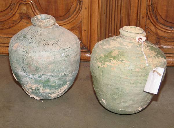 Appraisal: A group of six green glazed terracotta storage jars th