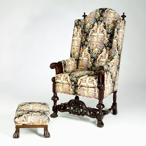 Appraisal: Dutch-style overscaled wing chair with heavily carved front stretcher turned