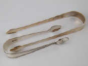 Appraisal: A pair of brightcut silver sugar tongs London and an