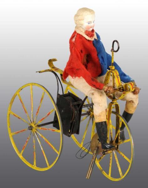 Appraisal: Early Bisque Head Doll on Velocipede Wind-Up Toy Description French