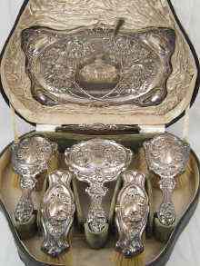 Appraisal: A boxed silver dressing table set embossed with cherubs in