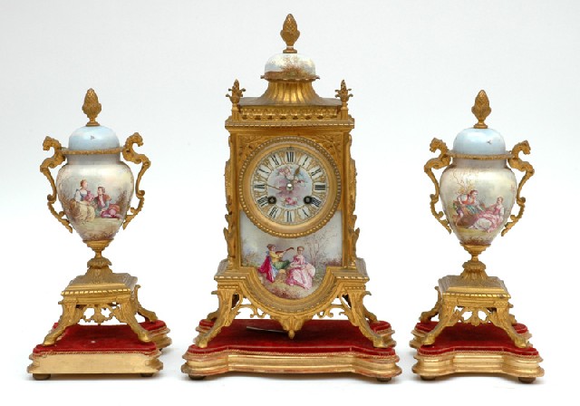 Appraisal: A FRENCH GILT METAL CLOCK GARNITURE Having an eight-day gong