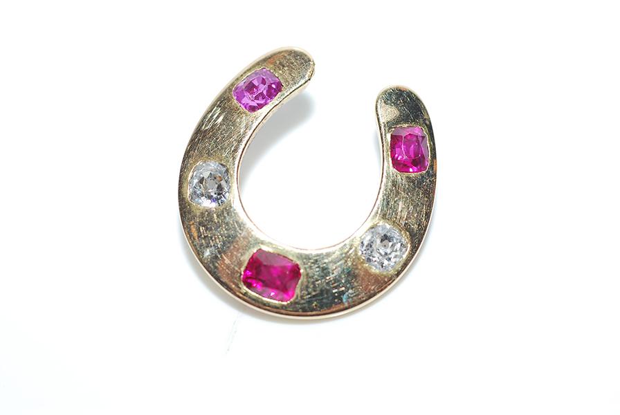 Appraisal: AN ANTIQUE RUBY AND DIAMOND HORSESHOE BROOCH A F AN