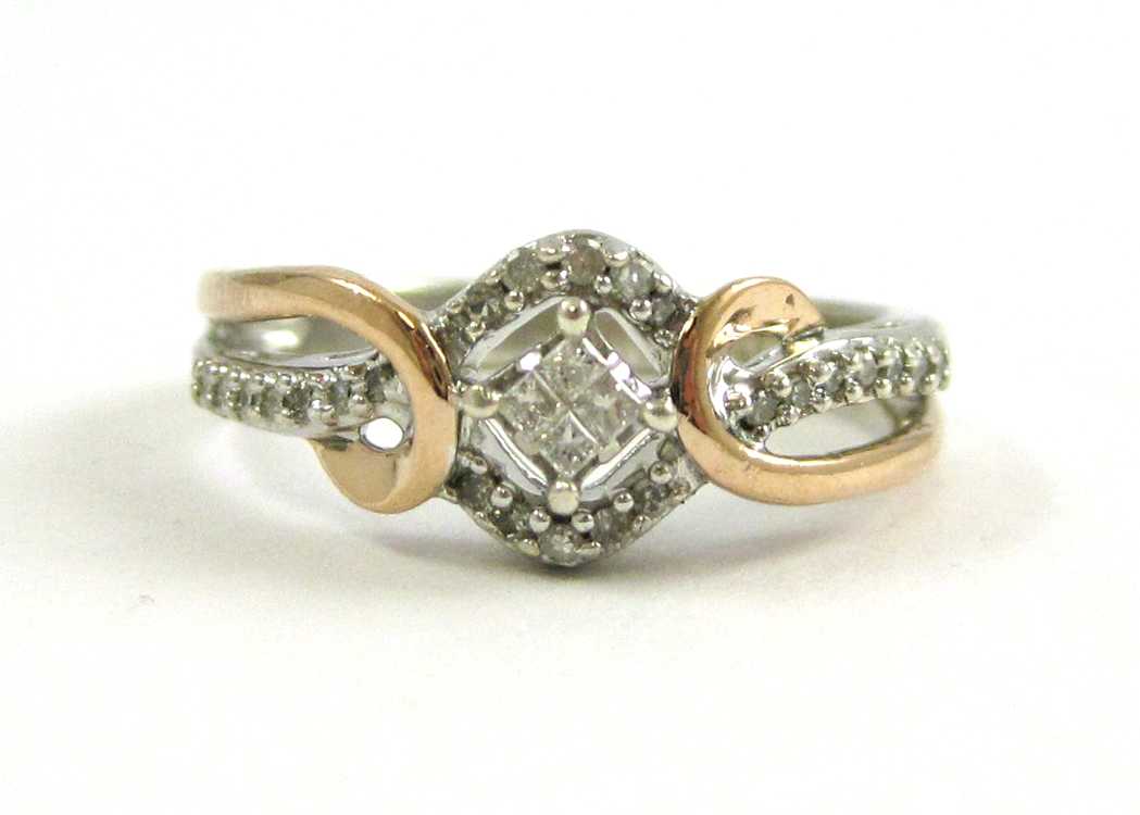 Appraisal: DIAMOND SILVER AND YELLOW GOLD RING The sterling silver and