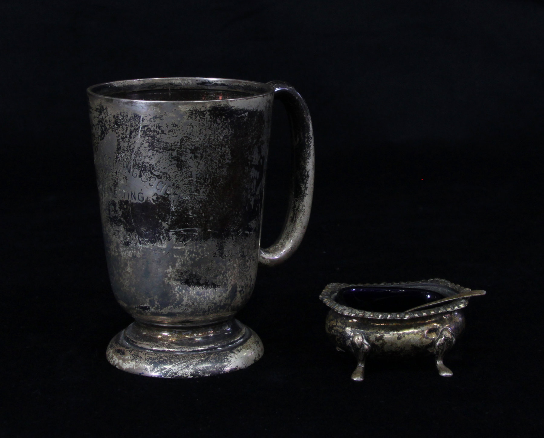 Appraisal: A silver trophy mug Walker Hall Sheffield with scroll handle