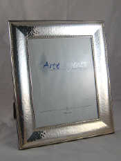 Appraisal: A large strut backed silver faced photo frame with hammered