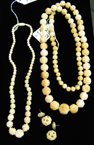 Appraisal: THREE CARVED IVORY JEWELRY PIECES are Ivory beaded necklaces one