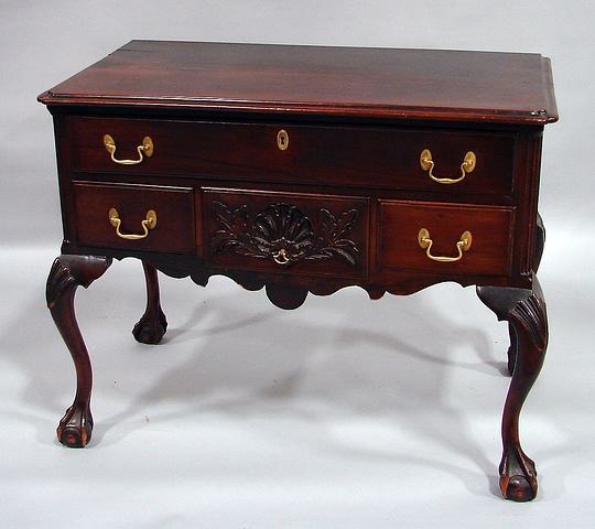 Appraisal: Molded top with invected corners thumb-molded frieze drawer over small