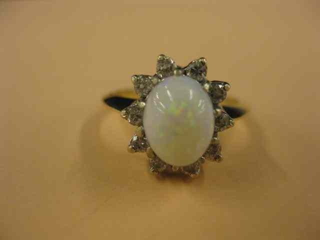 Appraisal: Opal Diamond Ring fiery oval cabachon surrounded by diamonds in